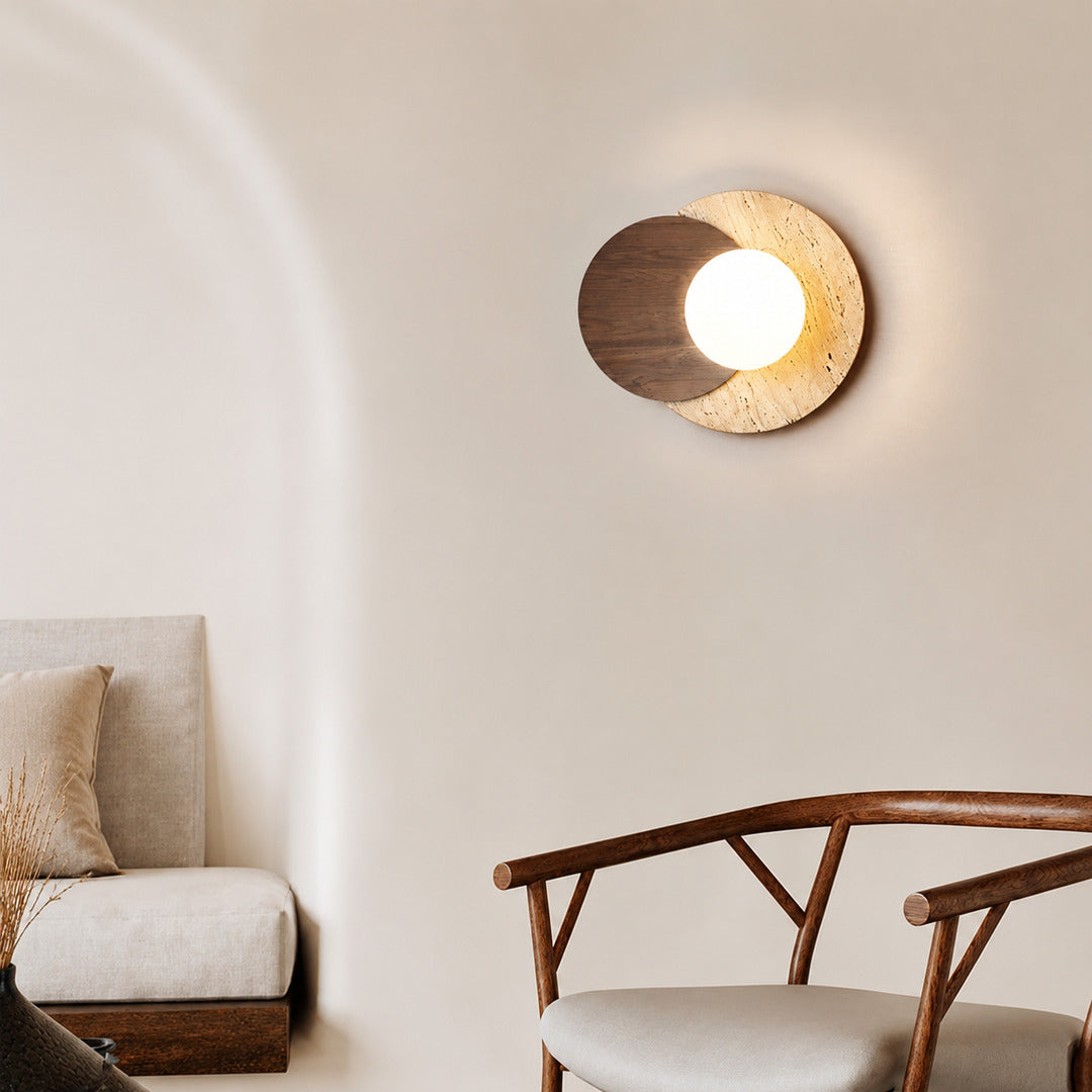 Eclisse travertine wall sconce living room wall warm glow glass globe travertine stone wood sculptural American home lifestyle interior styled