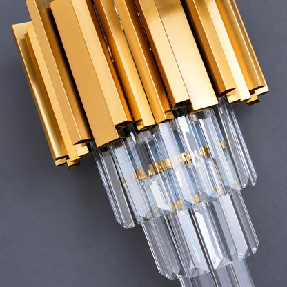 Warm light refracting through the precision-cut crystals of the Empire wall sconce scattering glints on the wall