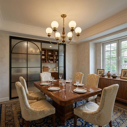 Elegant Estelle Wood and Glass Chandelier illuminating a classical French vintage dining room with a long wooden table set by Stuber Lighting.
