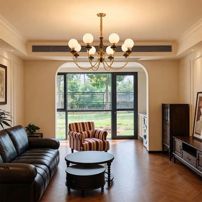 Sophisticated Estelle wood and brass chandelier paired with a ceiling medallion in a retro French style living room by Stuber Lighting.
