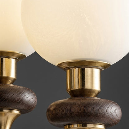 Estelle wood glass chandelier above dining table warm Edison filament glow French farmhouse interior