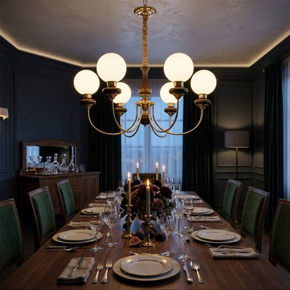Estelle wood glass chandelier above dining table warm Edison filament glow French farmhouse interior