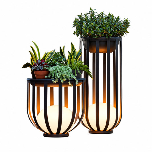 Faceta outdoor garden light with a geometric faceted black frame glowing warm on a garden lawn