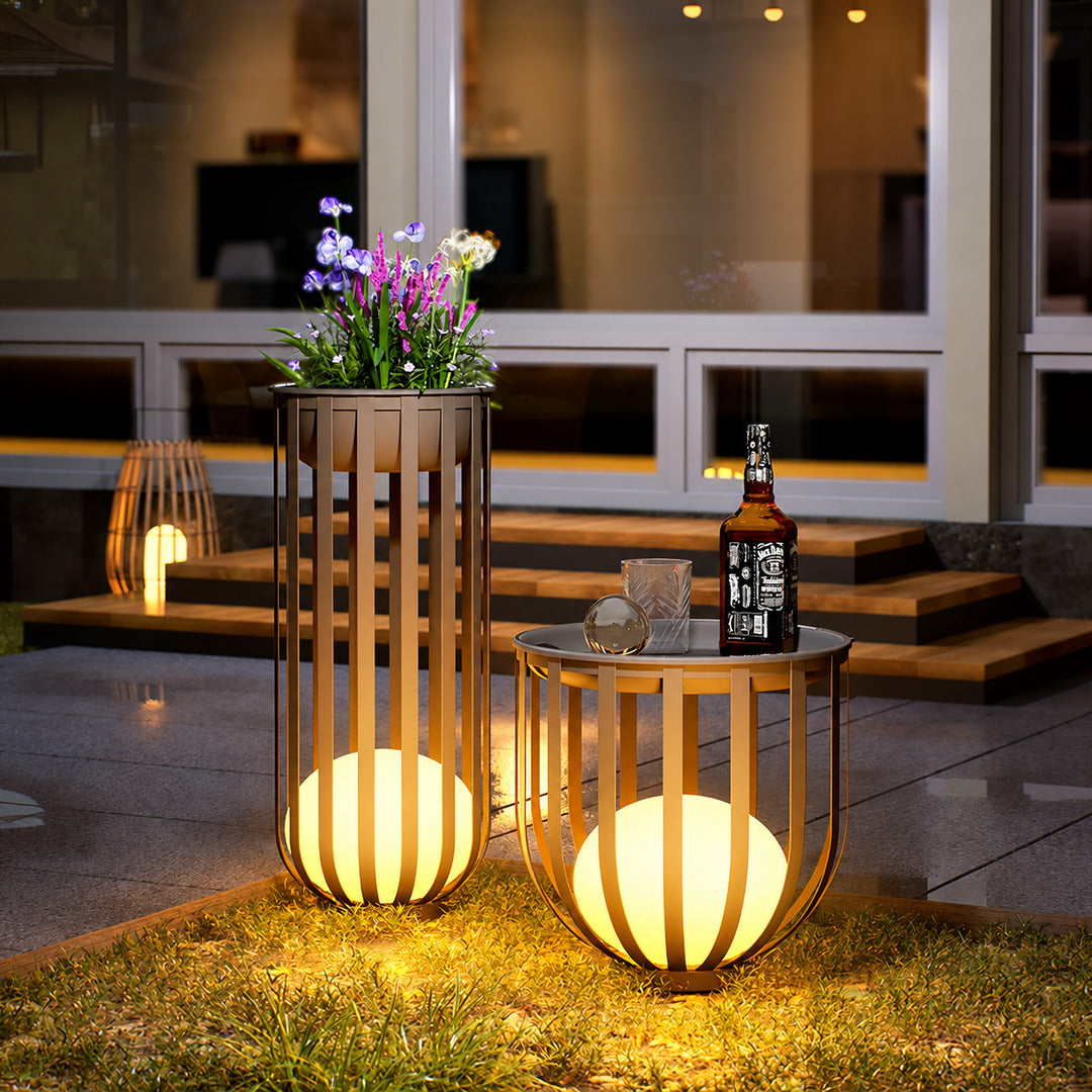 Row of Faceta outdoor garden lights marking a garden pathway with warm light