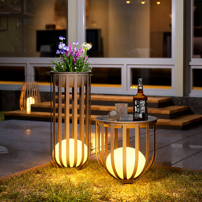 Row of Faceta outdoor garden lights marking a garden pathway with warm light