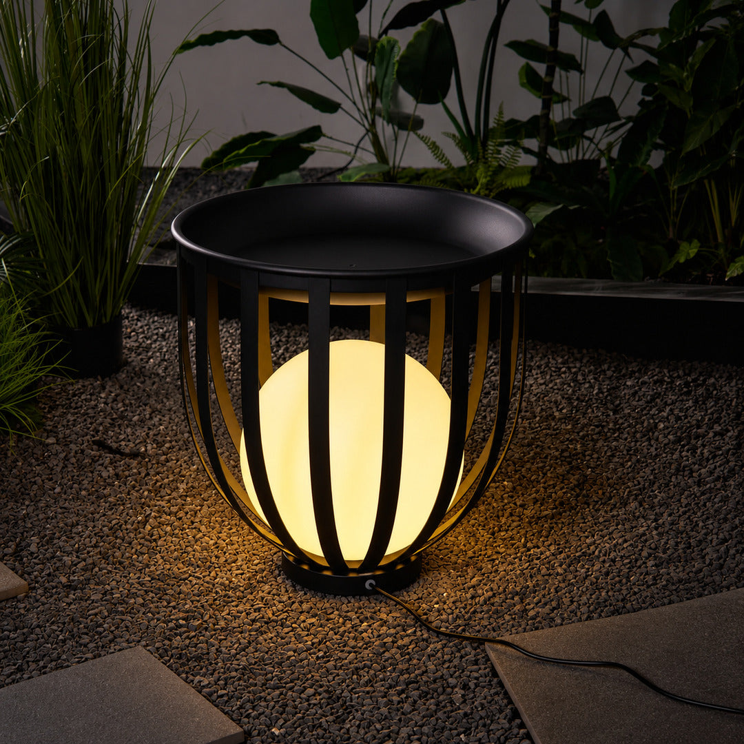 Row of Faceta outdoor garden lights marking a garden pathway with warm light