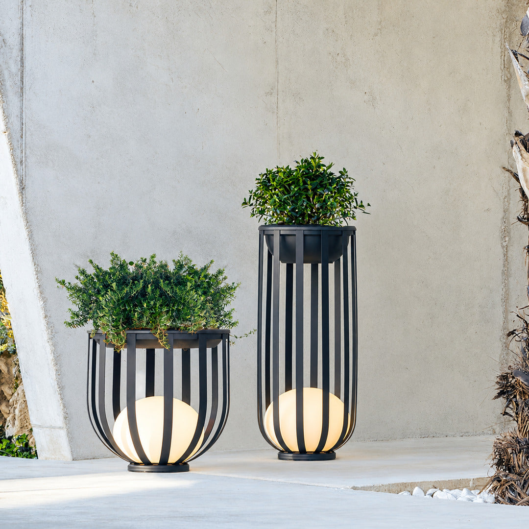Row of Faceta outdoor garden lights marking a garden pathway with warm light