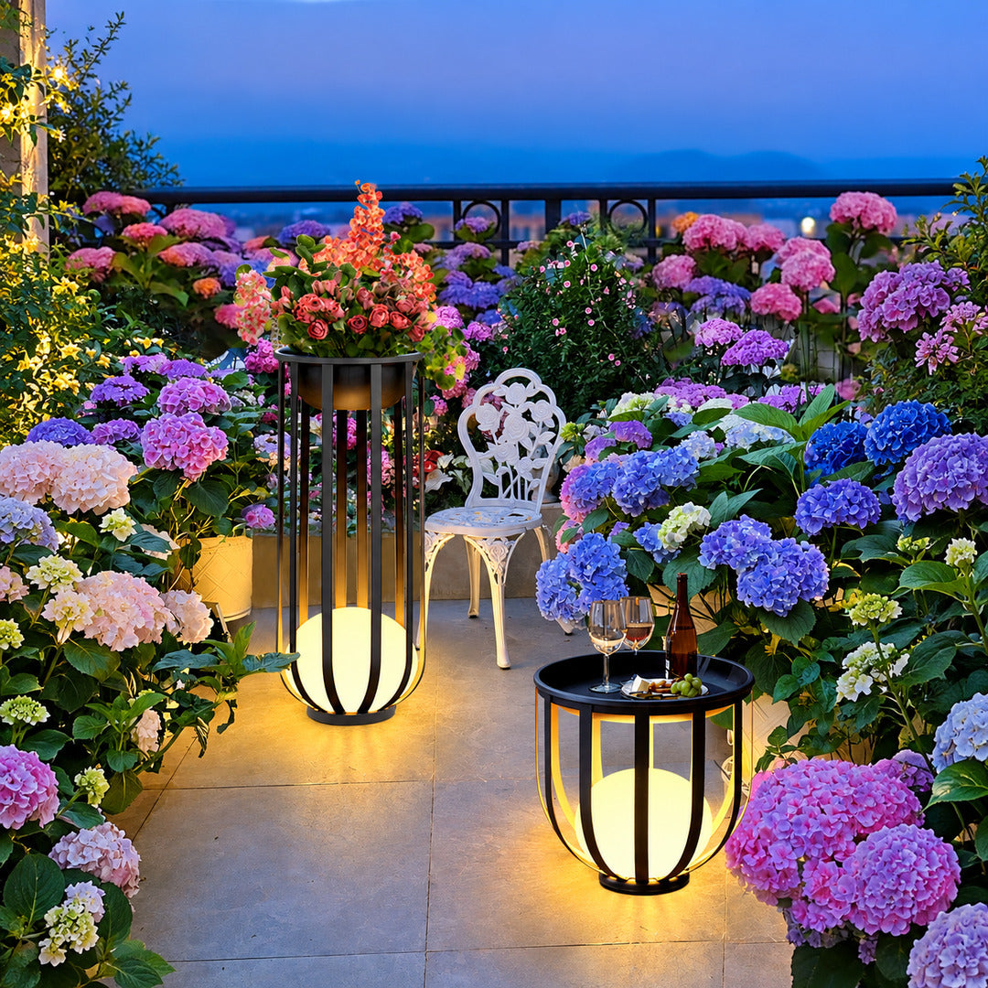 Faceta outdoor garden lights glowing warmly across a garden lawn at dusk