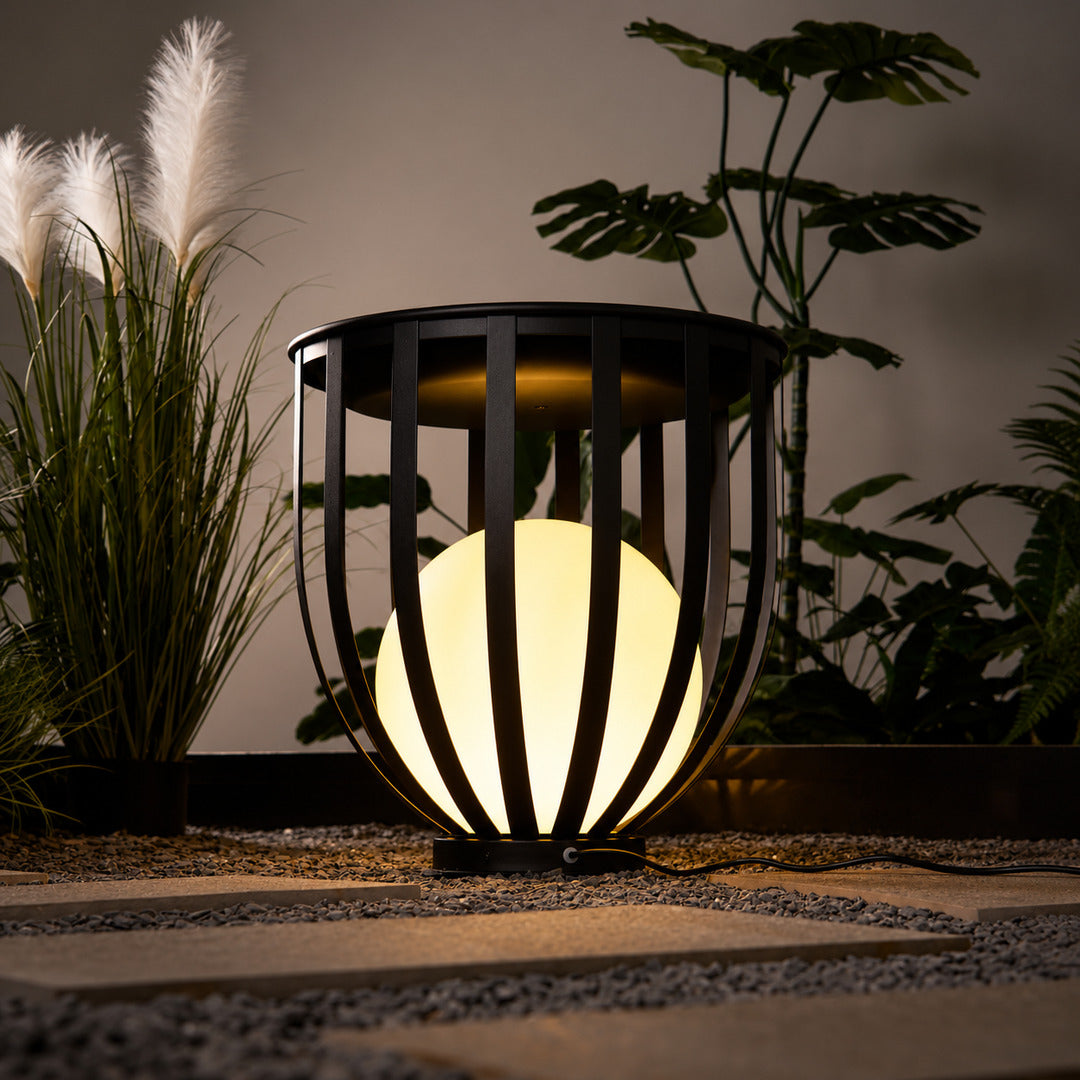 Row of Faceta outdoor garden lights marking a garden pathway with warm light