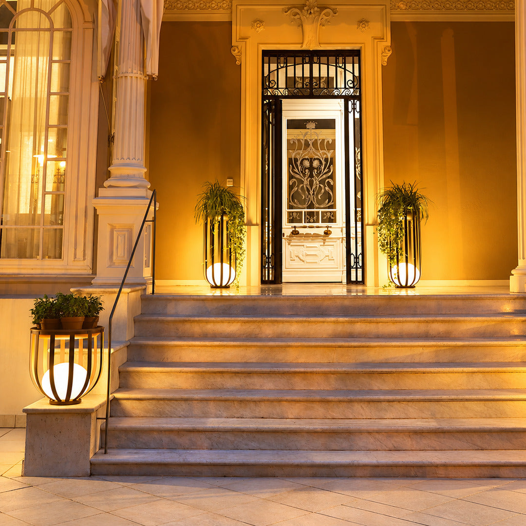 Pair of Faceta outdoor garden lights framing a front entrance with a warm geometric glow
