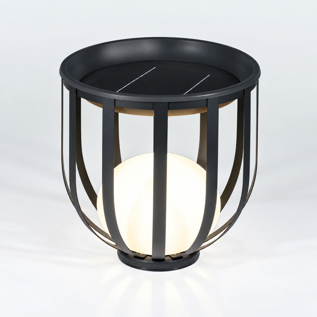 Low 21.3-inch solar Faceta outdoor garden light glowing on a garden lawn