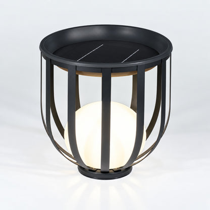 Low 21.3-inch solar Faceta outdoor garden light glowing on a garden lawn