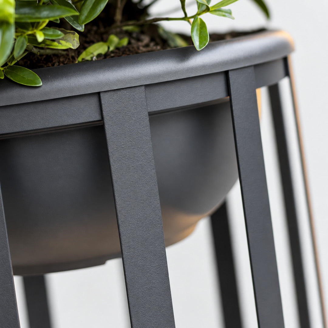 Faceta outdoor garden light shown with an optional planter tray holding greenery