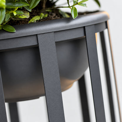 Faceta outdoor garden light shown with an optional planter tray holding greenery