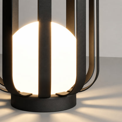 Warm light glowing through the translucent faceted panels of the Faceta outdoor garden light