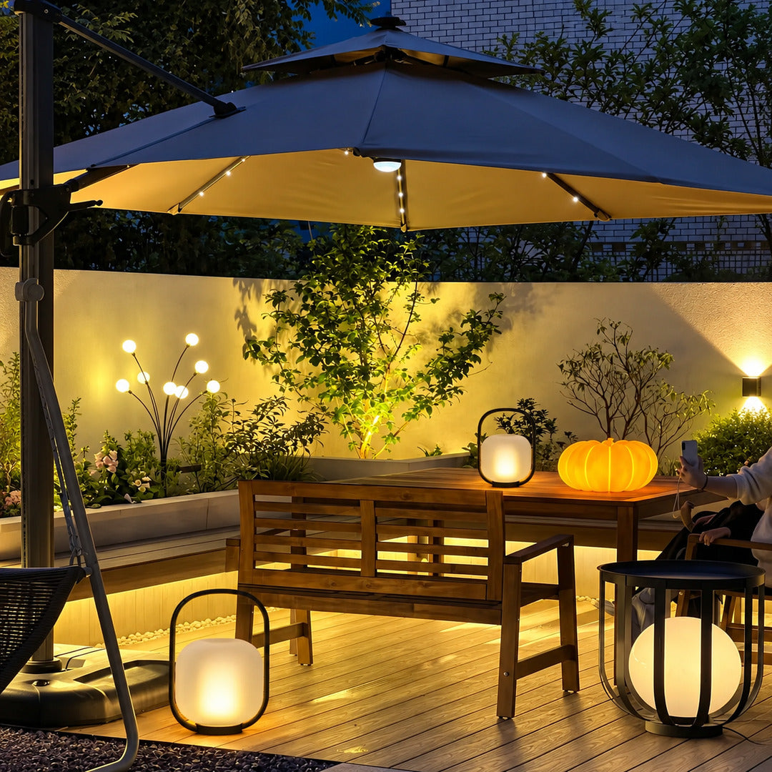 Falo portable lantern glowing warmly on a patio dining table at dusk