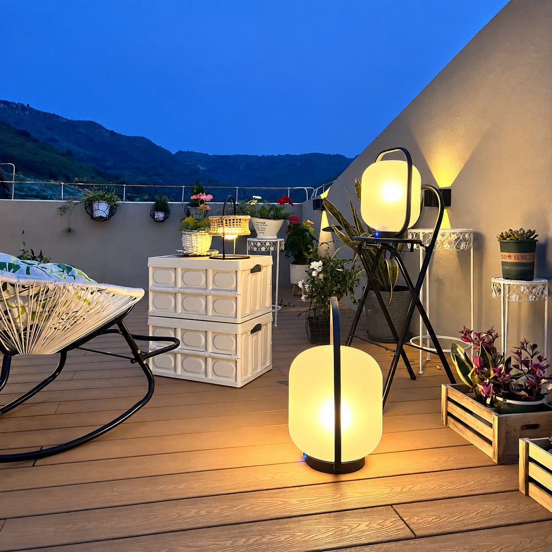 Falo portable lantern adding a cozy warm glow to a backyard deck gathering
