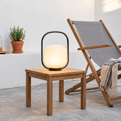 Falo portable lanterns setting a warm mood on a cafe outdoor seating area