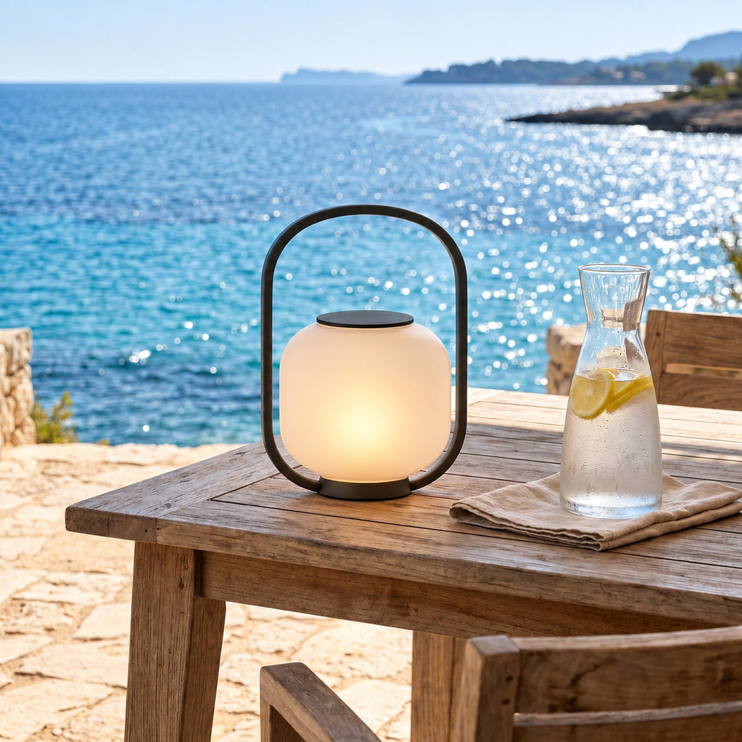 Falo portable lantern suiting a coastal garden with a warm inviting glow