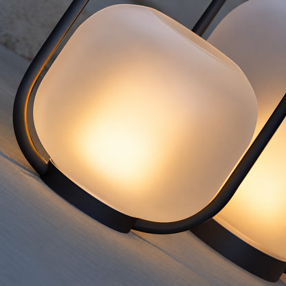 Detail of the frosted glass shade diffusing a warm cozy glow on the Falo portable lantern