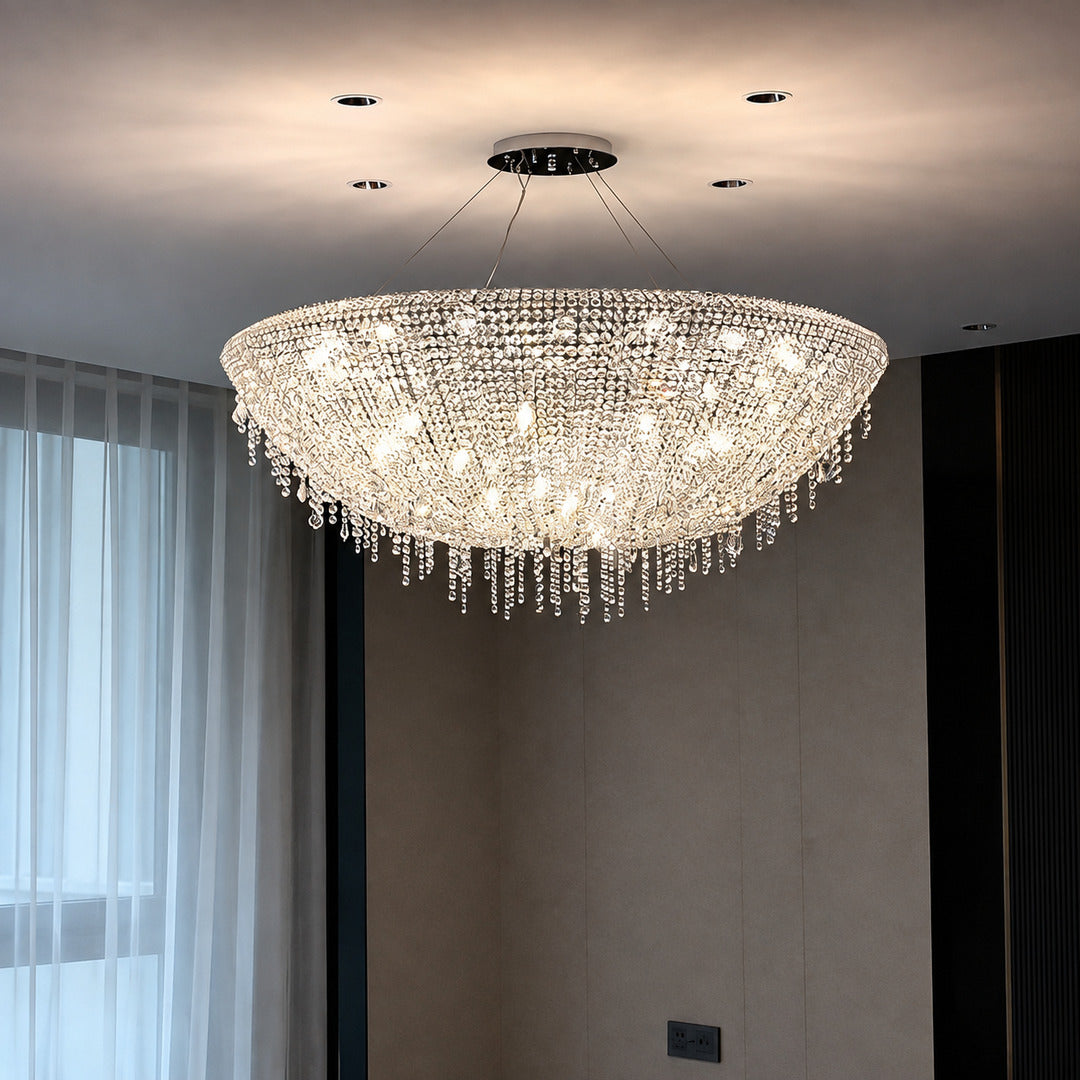 Fiocco crystal chandelier creating a glamorous glow in a primary bedroom