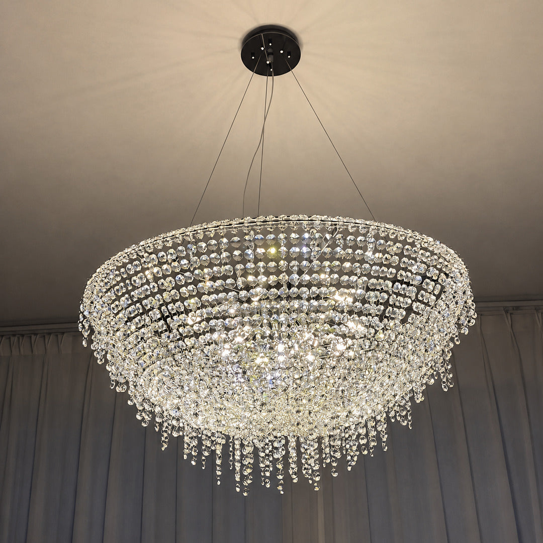 Fiocco crystal chandelier creating a glamorous glow in a primary bedroom