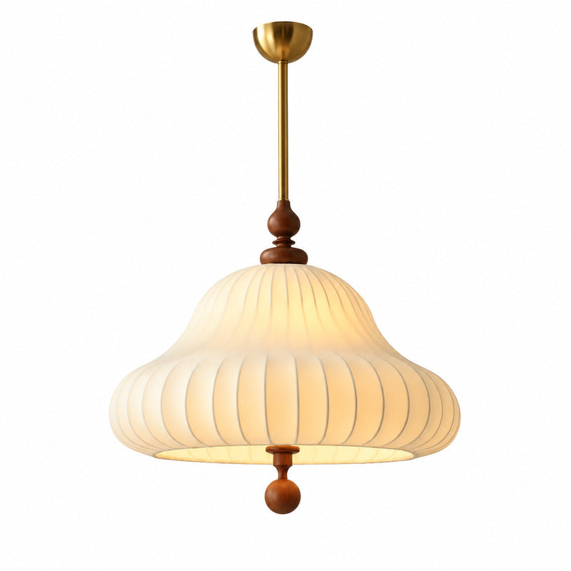 Fiorita pendant light with a blooming layered flower-petal shade glowing warm over a dining table