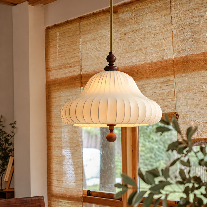 Fiorita blooming flower pendant casting a warm glow over a cozy corner reading nook