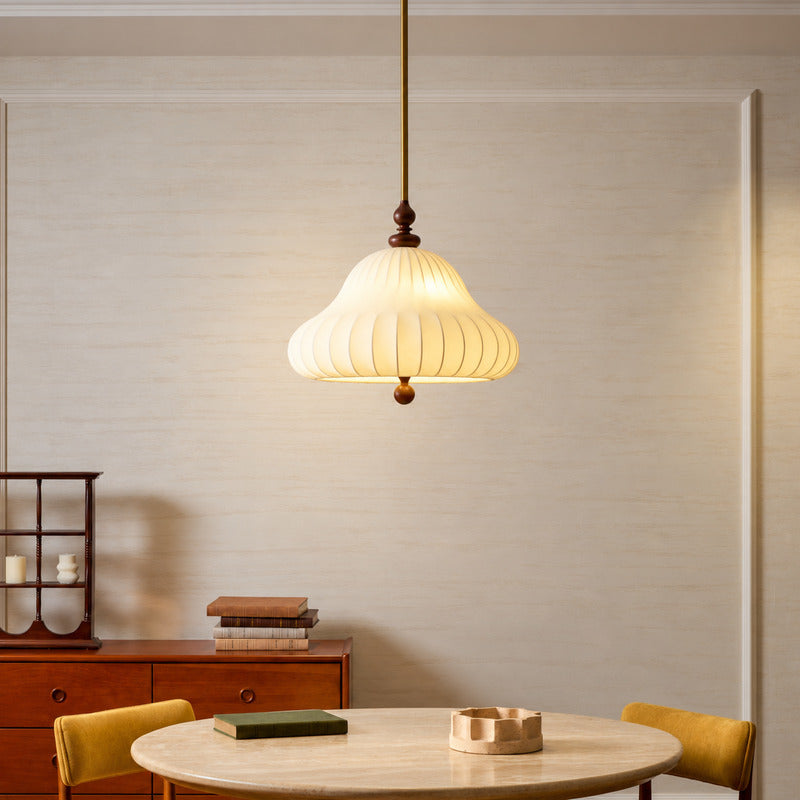 Fiorita blooming flower pendant casting a warm romantic glow over an elegant dining table