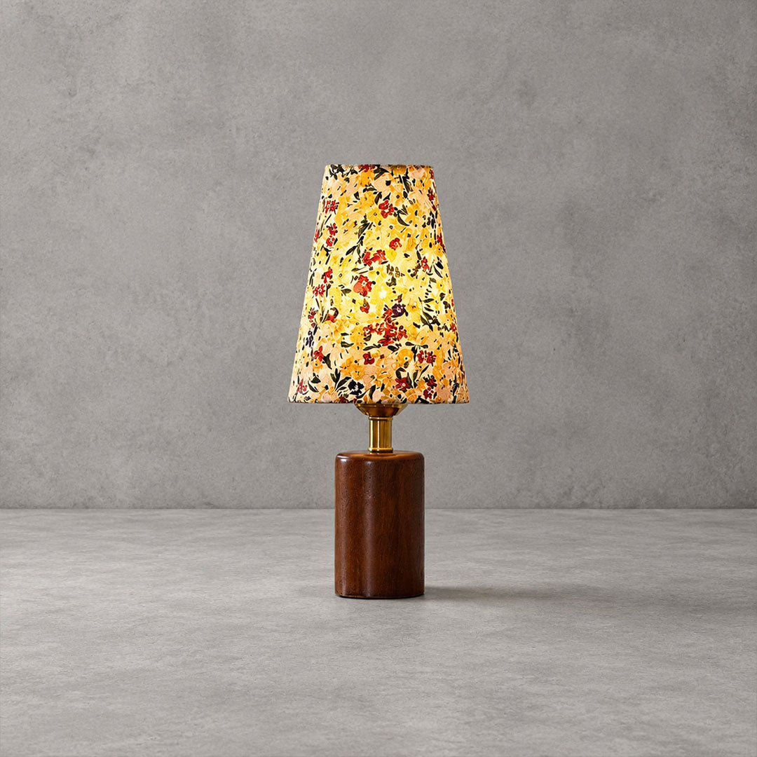 Fleur floral table lamp illuminated warm cozy glow floral fabric shade wood vintage white background
