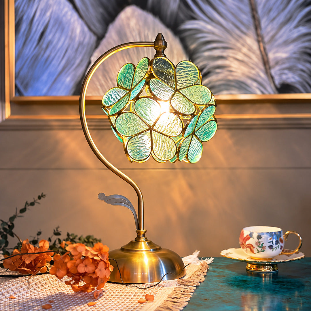 Foglia green glass leaf table lamp as a decorative accent on a living room side table