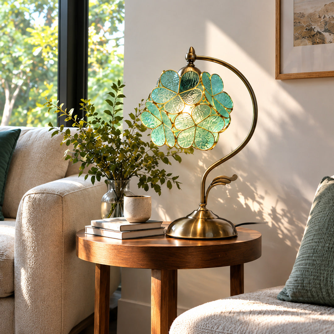 Foglia green glass leaf table lamp as a decorative accent on a living room side table