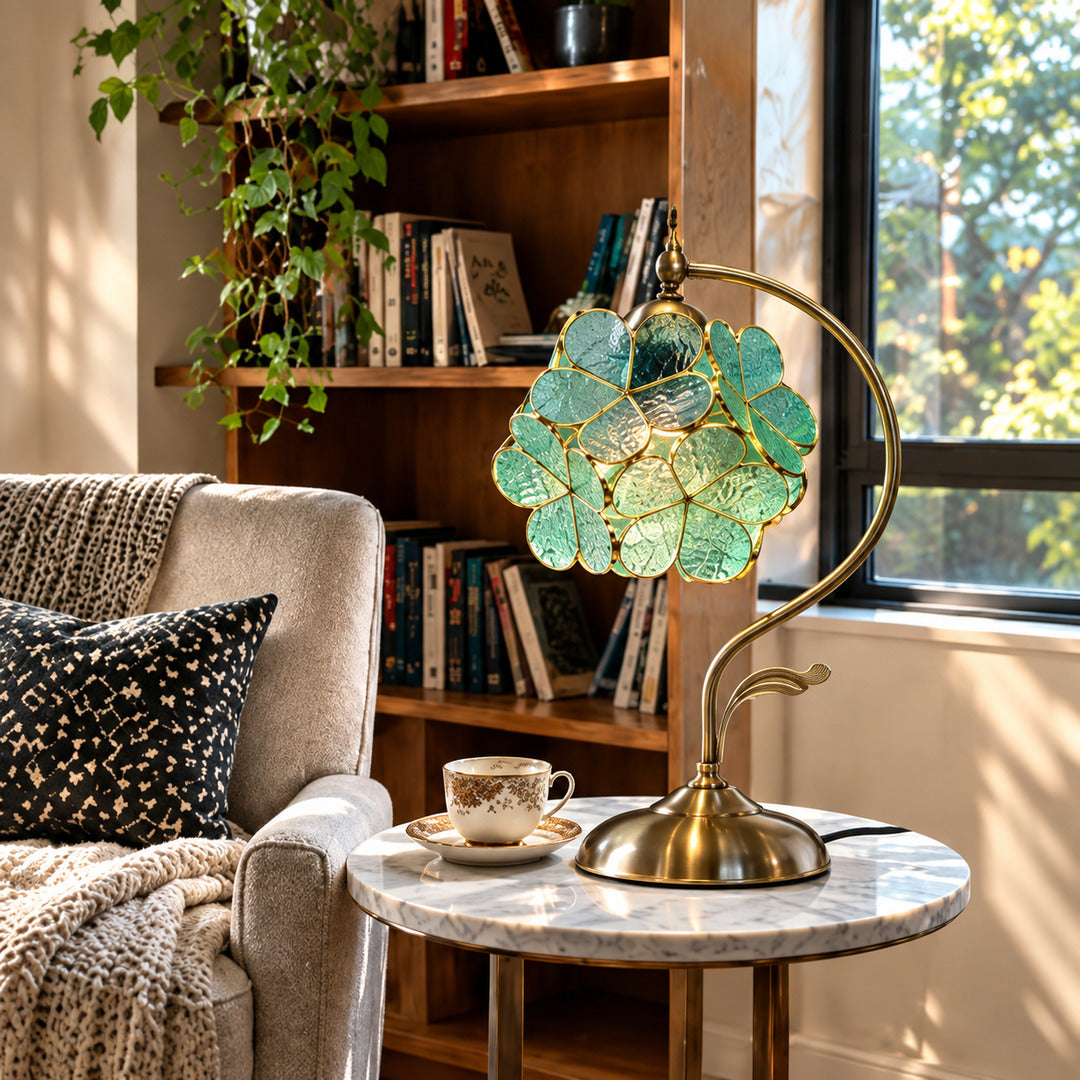 Foglia glass table lamp lighting a cozy corner reading nook with a warm green glow