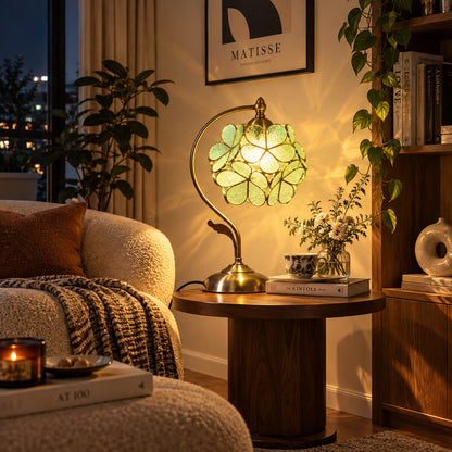 Foglia glass table lamp lighting a cozy corner reading nook with a warm green glow