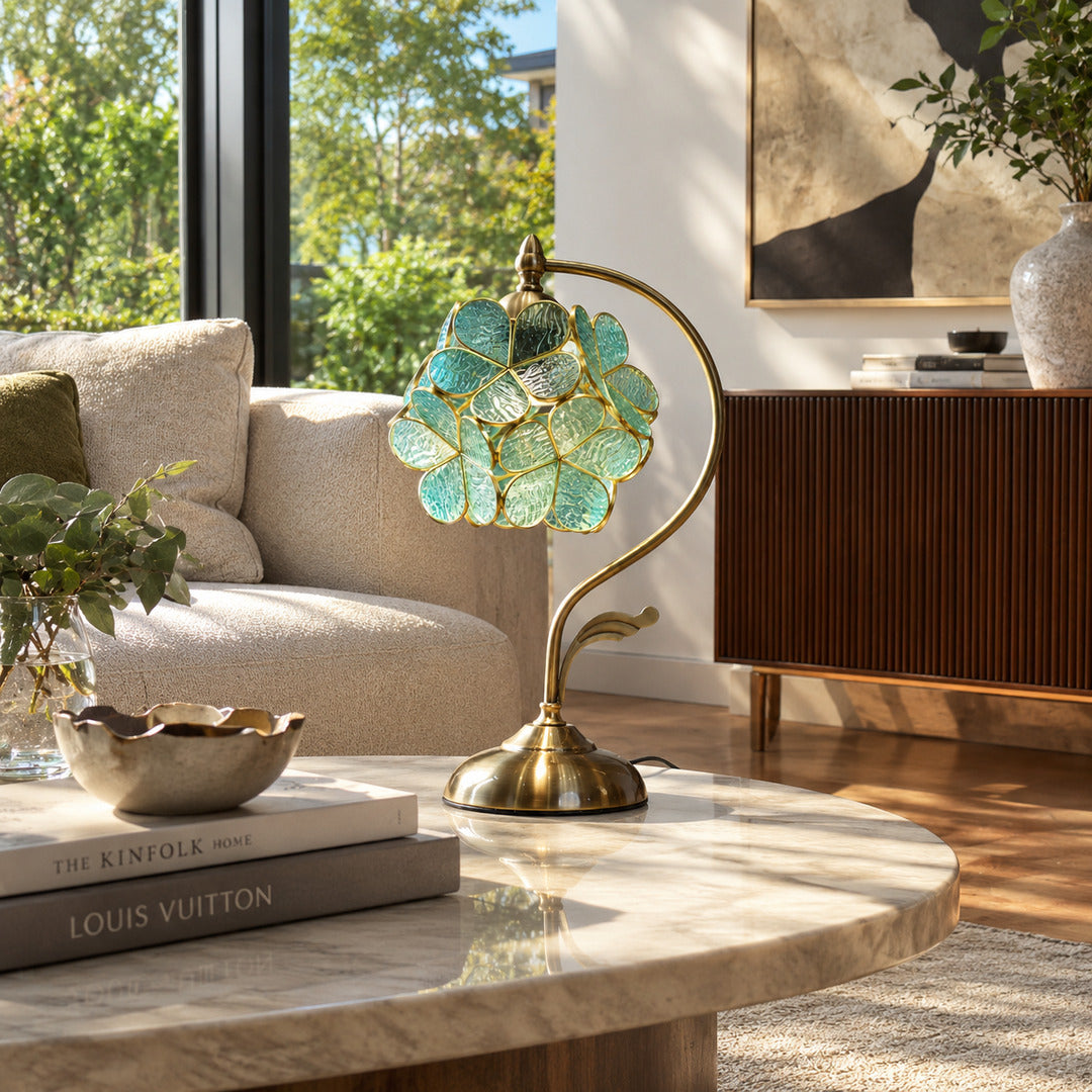 Foglia green glass leaf table lamp as a decorative accent on a living room side table
