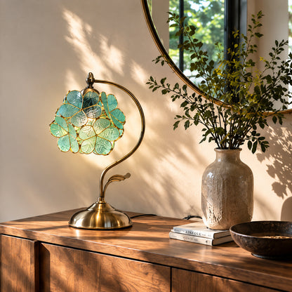 Foglia glass leaf table lamp adding a warm decorative accent to an entryway console