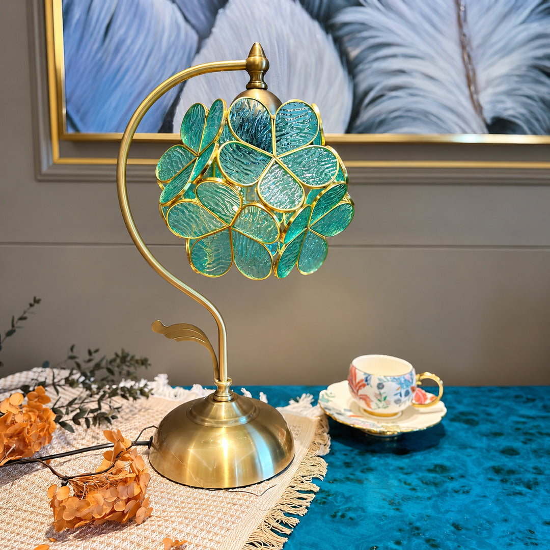 Foglia green glass leaf table lamp as a decorative accent on a living room side table