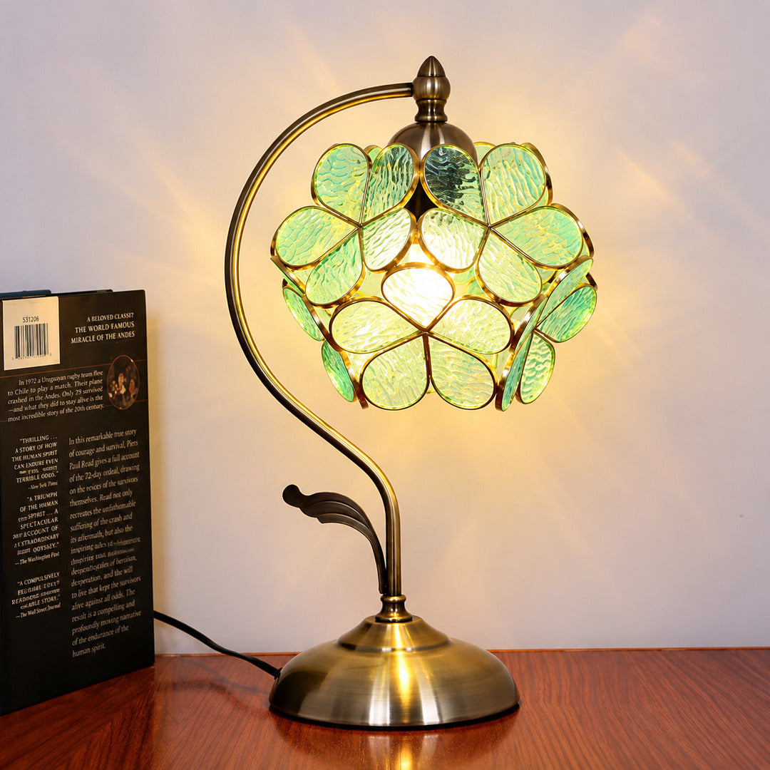 Foglia glass table lamp lighting a cozy corner reading nook with a warm green glow