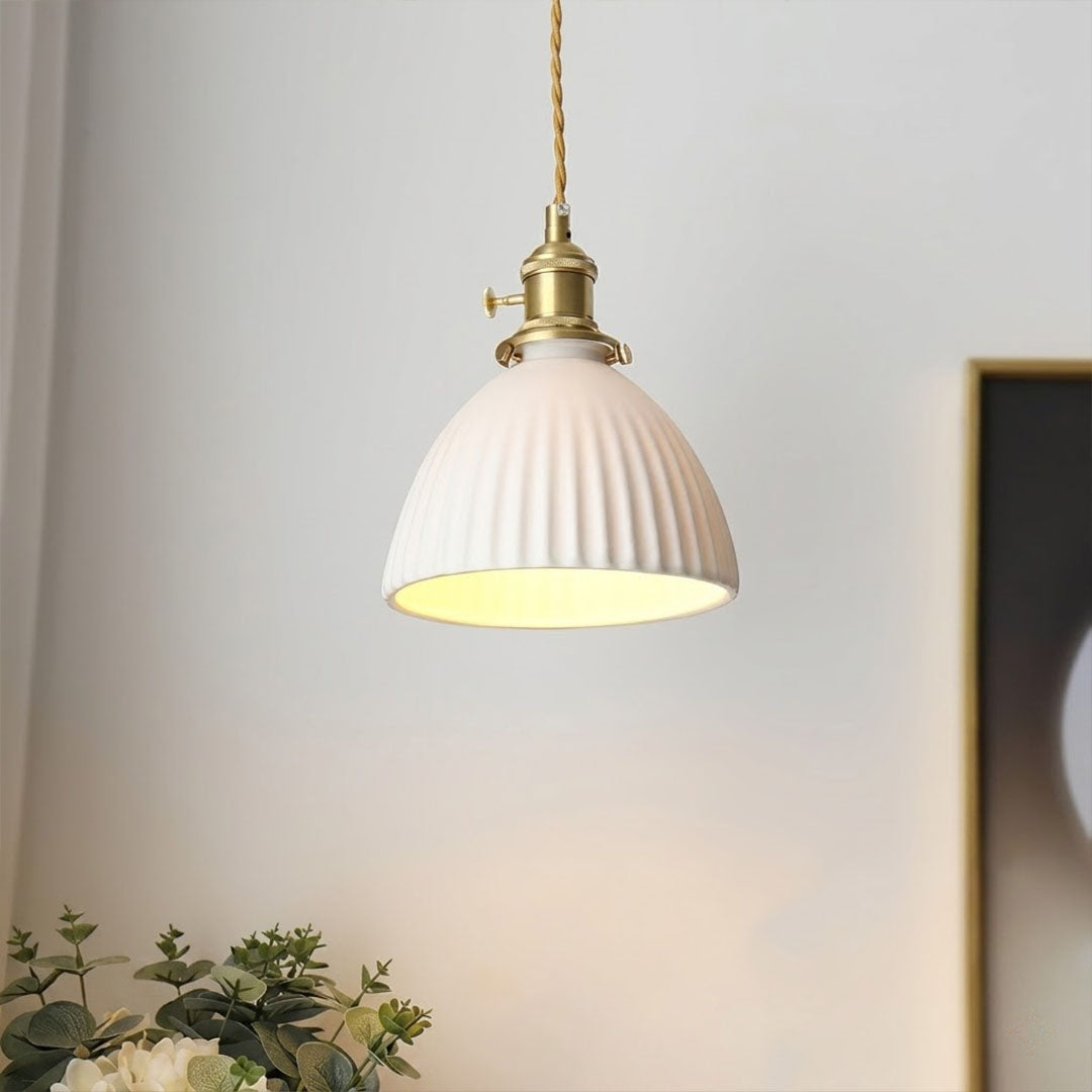 Freya polished brass stem pleated ceramic shade illuminated warm soft glow close up detail Scandinavian