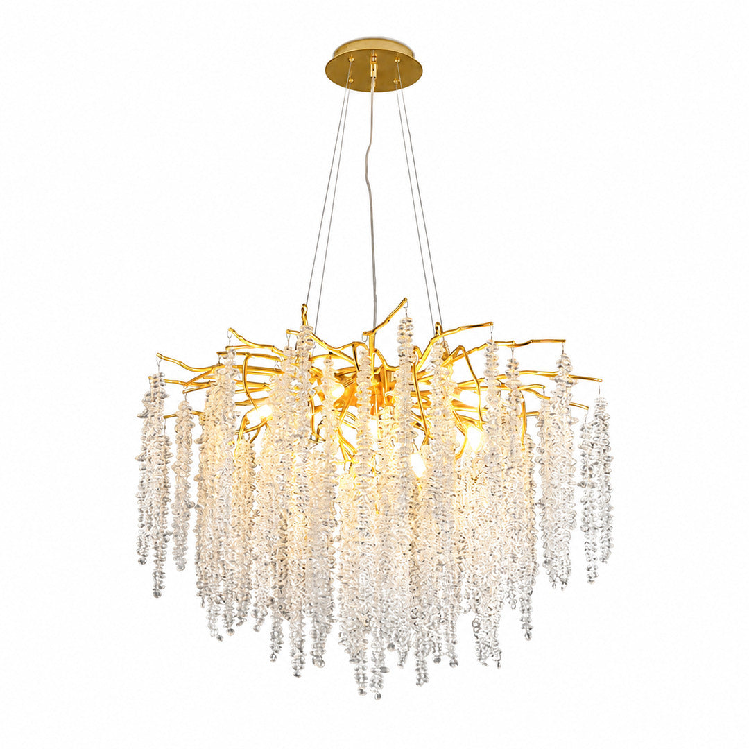 Fronda gold crystal chandelier with branching arms and cascading clear crystal strands over a dining table