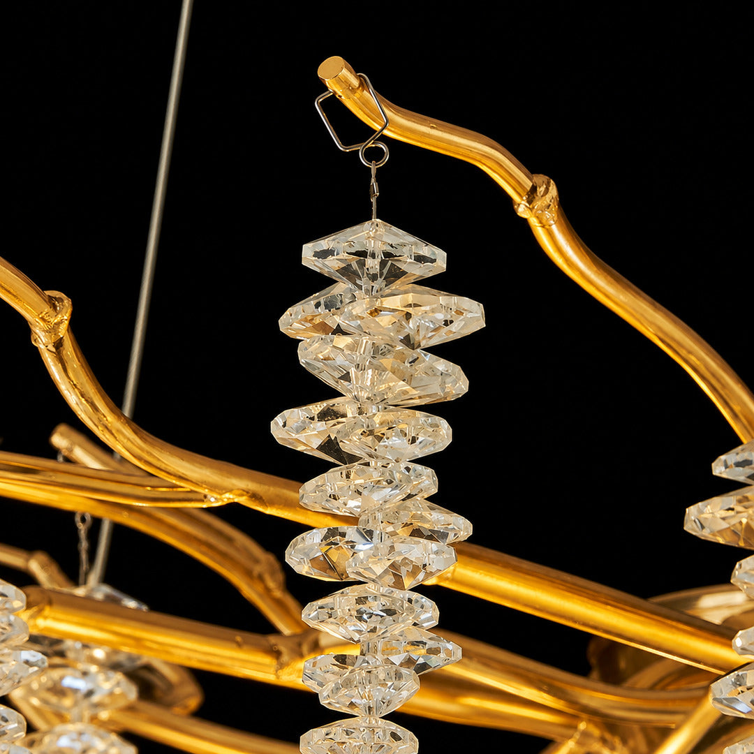 Detail of the brushed gold branching arms of the Fronda crystal chandelier