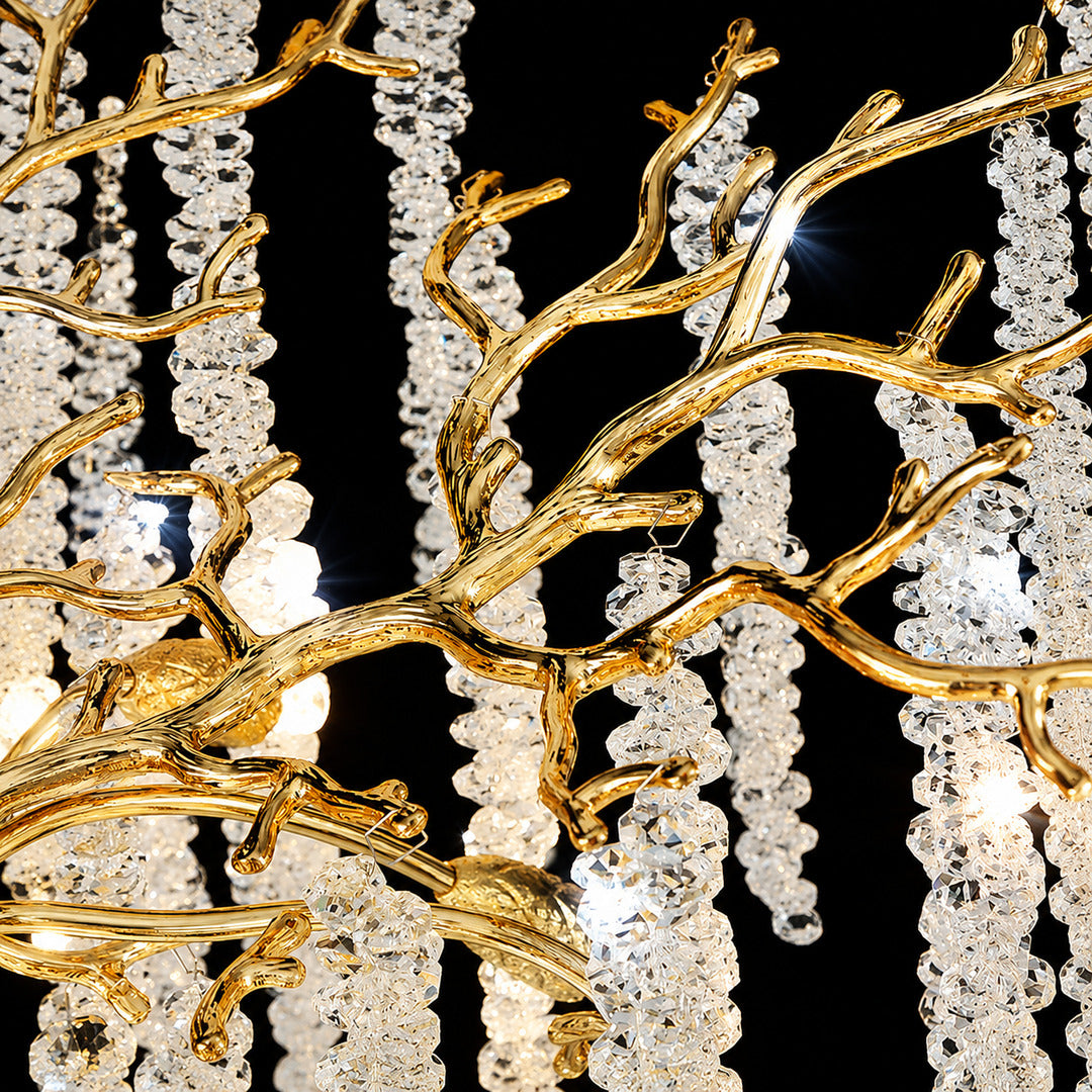Detail of the brushed gold branching arms of the Fronda crystal chandelier