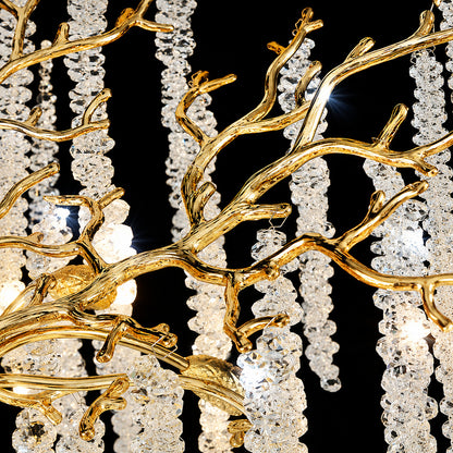 Detail of the brushed gold branching arms of the Fronda crystal chandelier