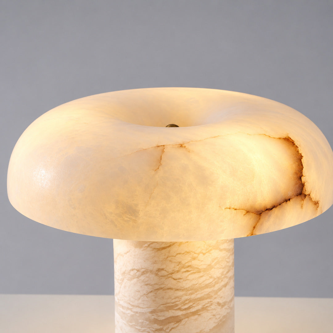 Close-up of natural veining glowing through the alabaster dome of the Fungo mushroom lamp