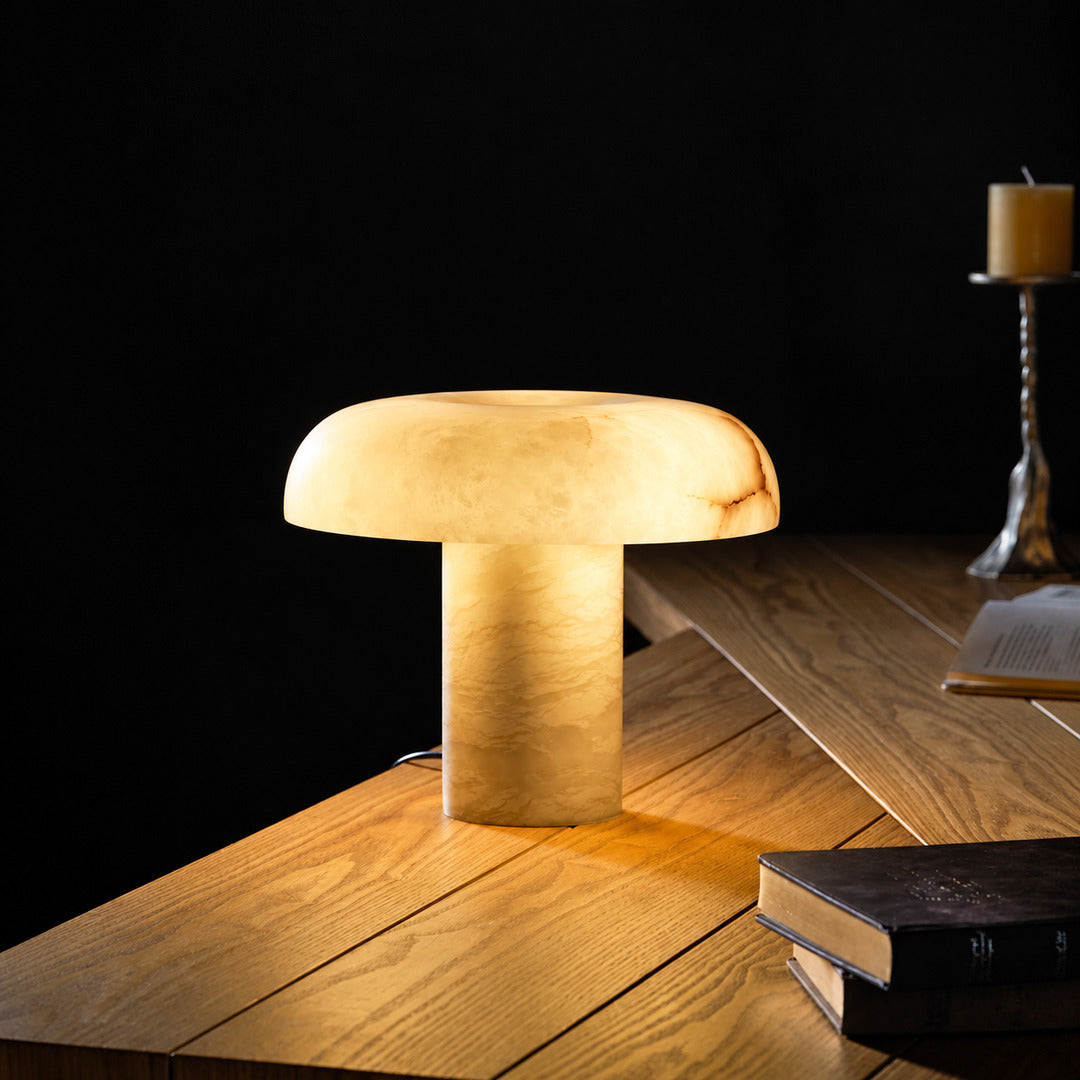 Warm evening glow of the Fungo alabaster mushroom lamp in a dark room