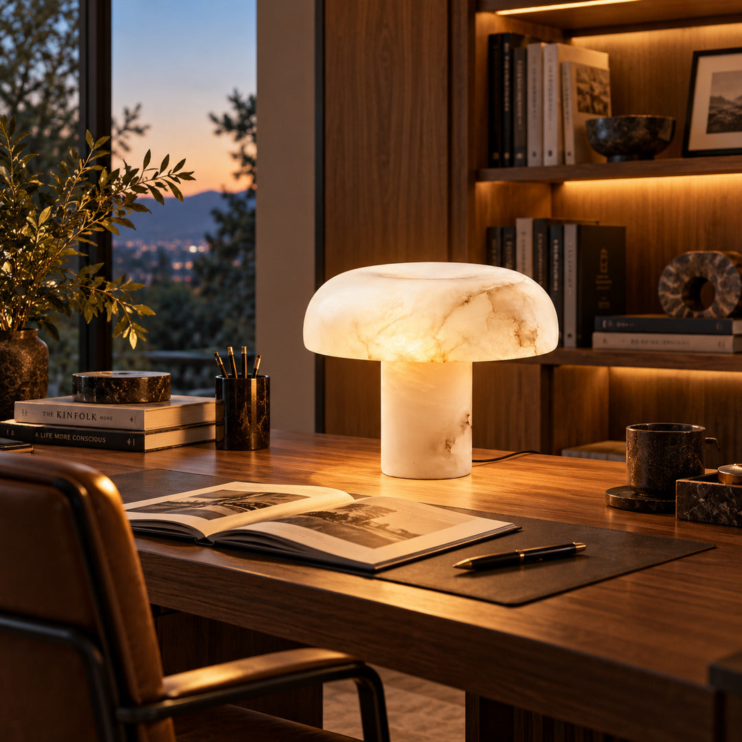 Fungo alabaster mushroom lamp sitting on a stack of books on a nightstand