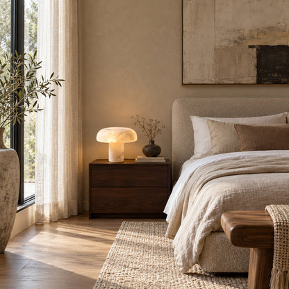 Pair of Fungo alabaster mushroom lamps on nightstands either side of a bed