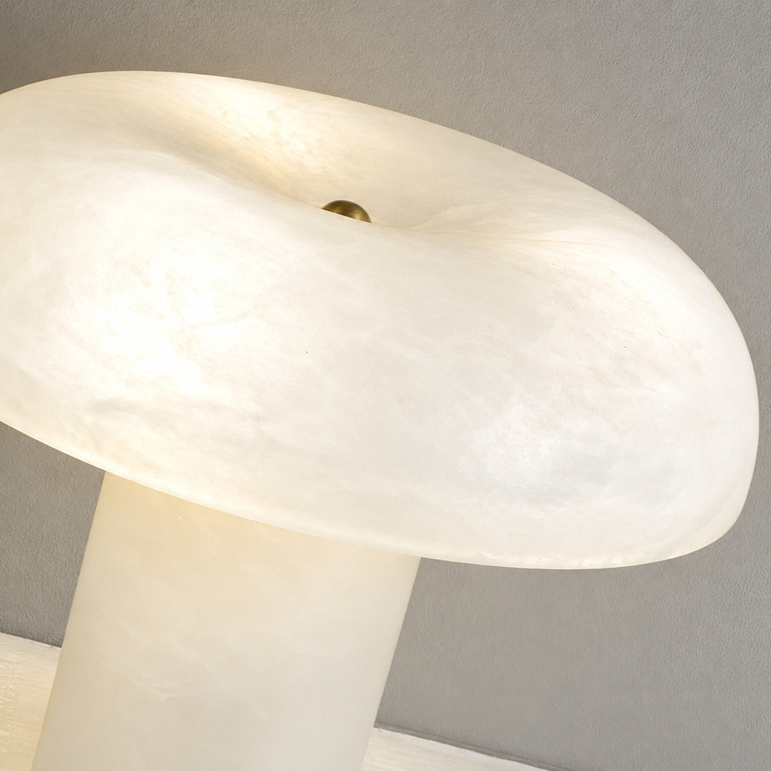 Close-up of natural veining glowing through the alabaster dome of the Fungo mushroom lamp