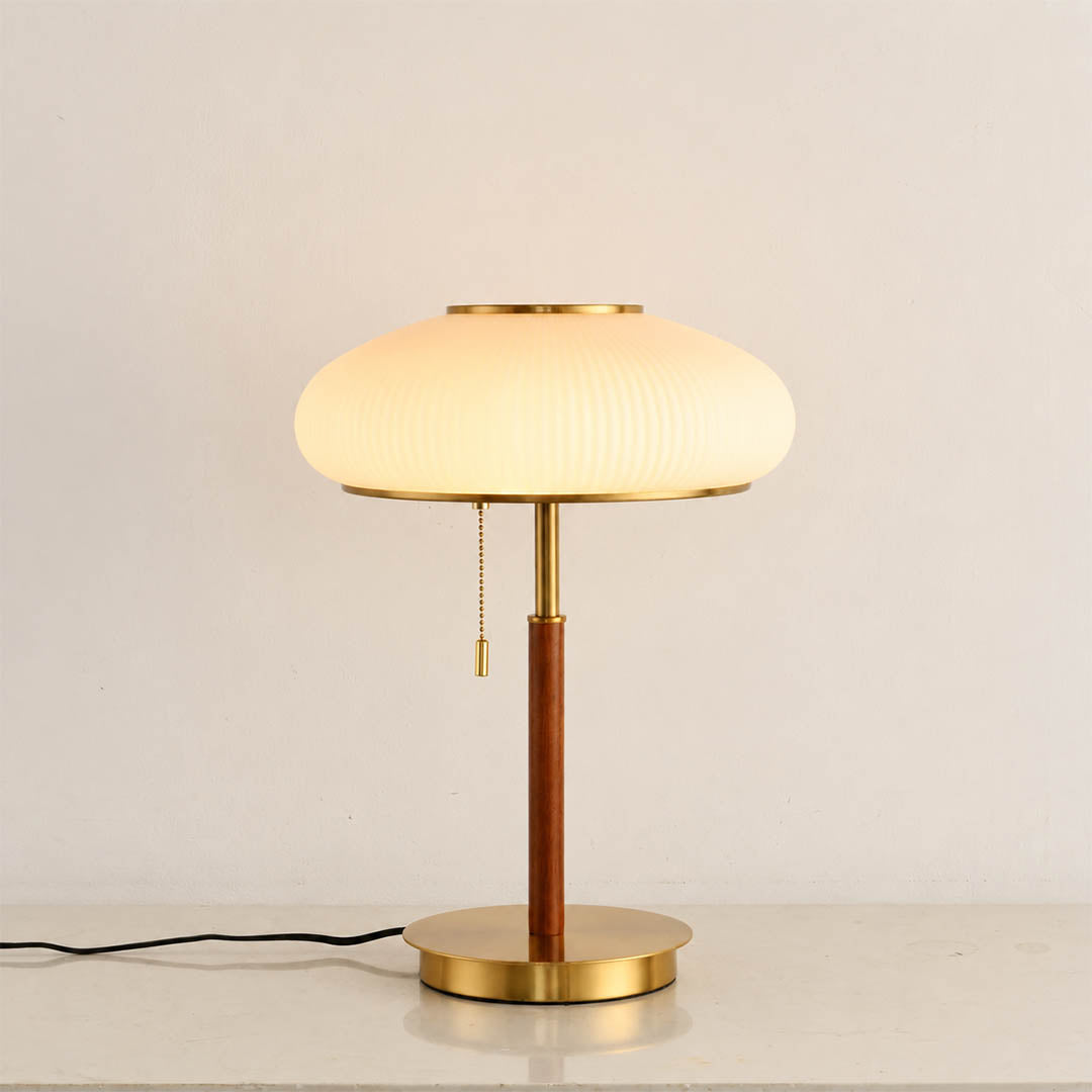 Fungo glass table lamp illuminated warm glow curved glass shade mushroom shape cozy white background