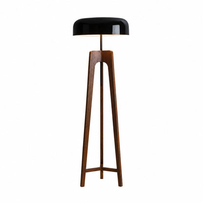 Fungo wood floor lamp with a handmade wood tripod base and a mushroom shade glowing warm in a living room